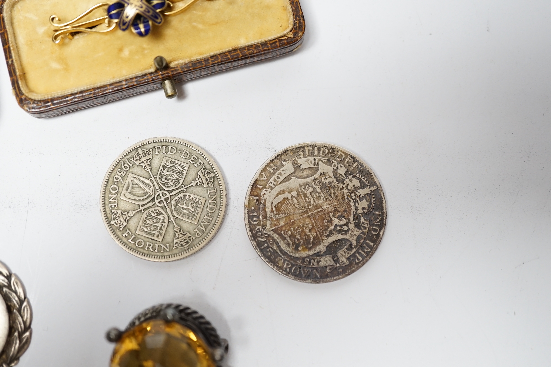 A pair of engine turned 9ct gold cufflinks, a yellow metal and enamel bar brooch, a white metal mounted citrine brooch, two silver medallions and two George V coins.